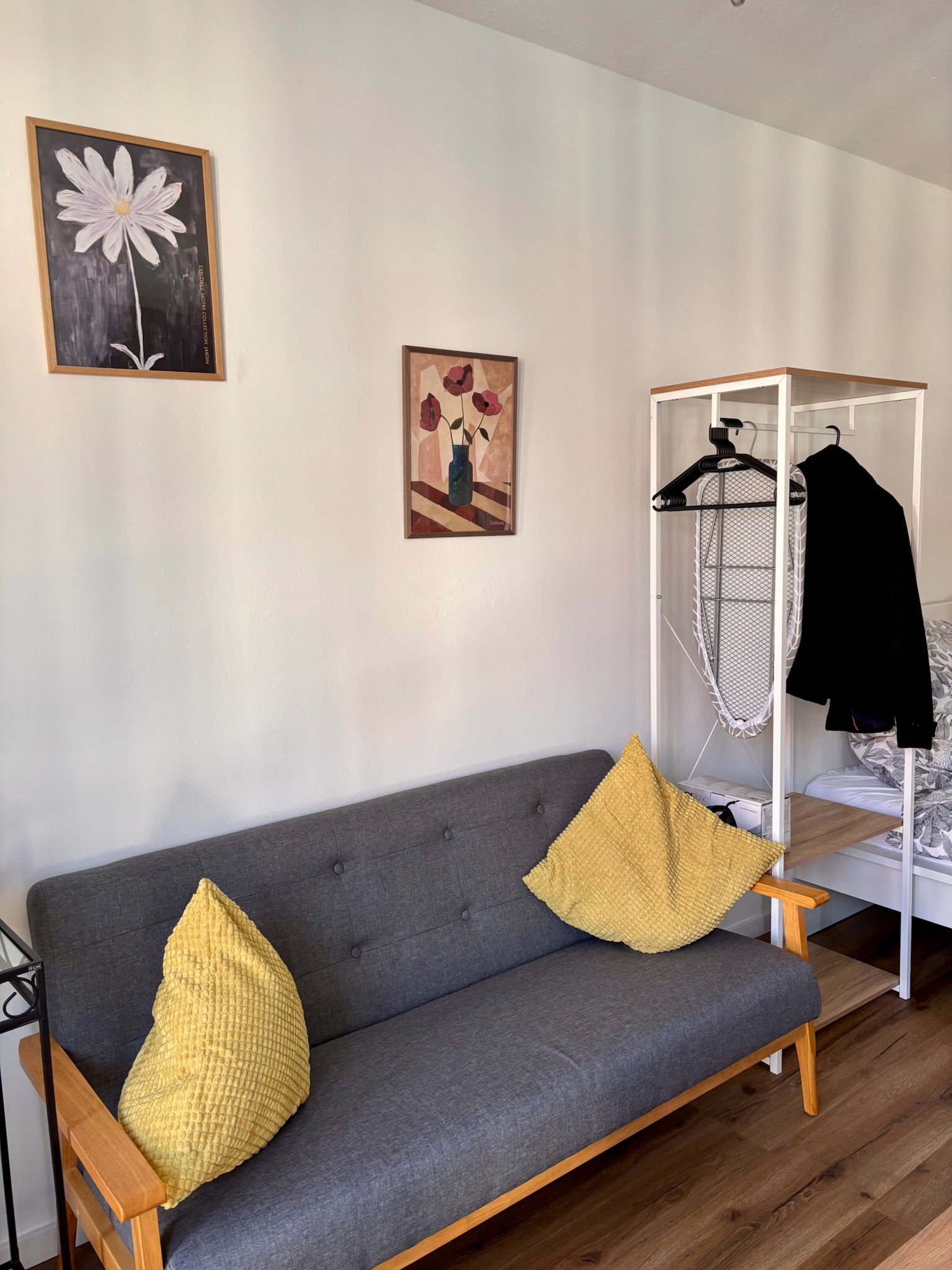 Grand Studio living area with sofa and yellow pillows